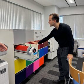 RisoLAB Director Pan Terzis pulls a drum out of a cabinet