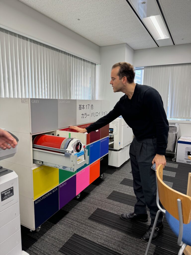 RisoLAB Director Pan Terzis pulls a drum out of a cabinet