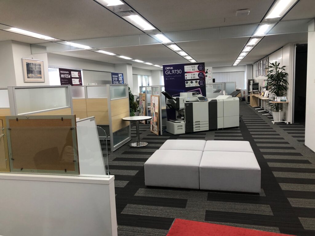 The view of an office with carpeting and drop ceilings