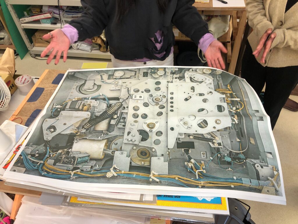 A large scale printed newspaper displaying the interior view of a Risograph duplicator